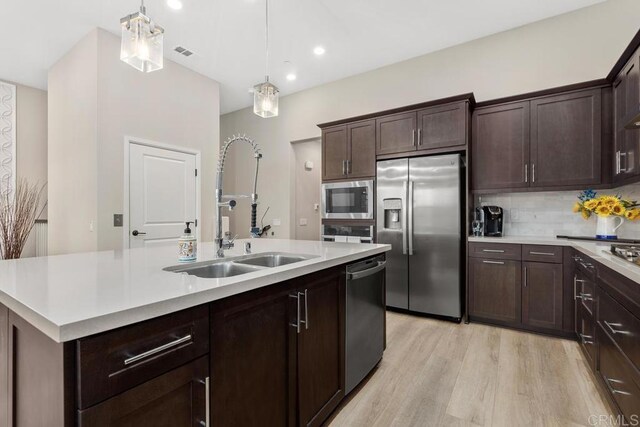 16750 Coyote Bush Dr Unit 107, San Diego, CA 92127 - kitchen with a sink, light countertops, appliances with stainless steel finishes, and pendant lighting