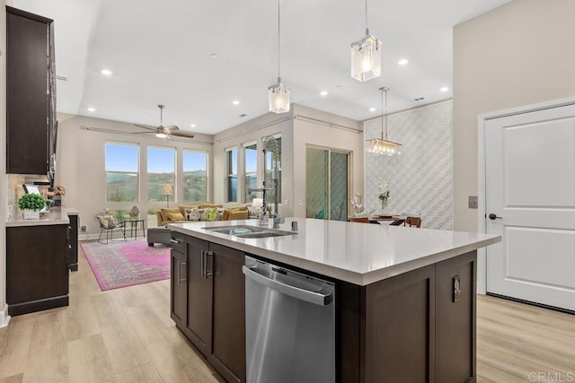 16750 Coyote Bush Dr Unit 107, San Diego, CA 92127 - kitchen featuring stainless steel dishwasher, light wood finished floors, a sink, and dark brown cabinets