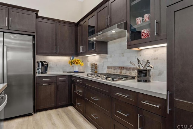 16750 Coyote Bush Dr Unit 107, San Diego, CA 92127 - kitchen featuring light countertops, dark brown cabinetry, under cabinet range hood, and stainless steel appliances