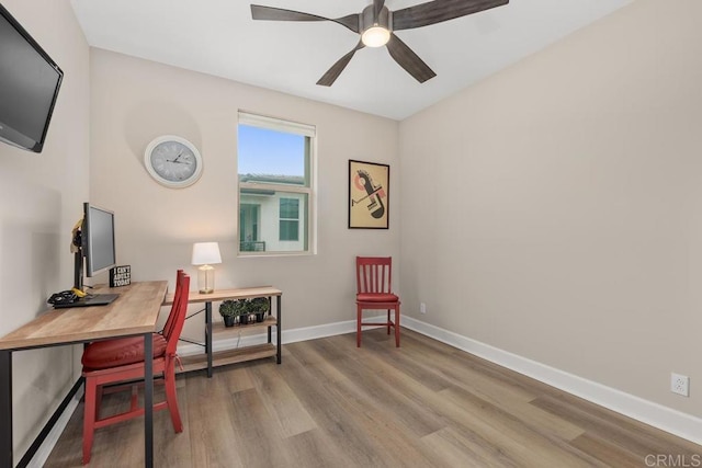 16750 Coyote Bush Dr Unit 107, San Diego, CA 92127 - home office featuring a ceiling fan, baseboards, and light wood-style floors