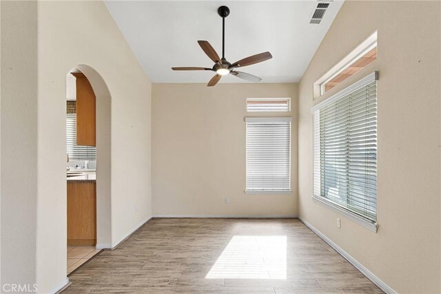 empty room featuring ceiling fan and light hardwood / wood-style flooring