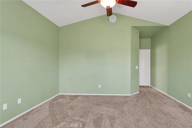 carpeted spare room featuring ceiling fan and lofted ceiling