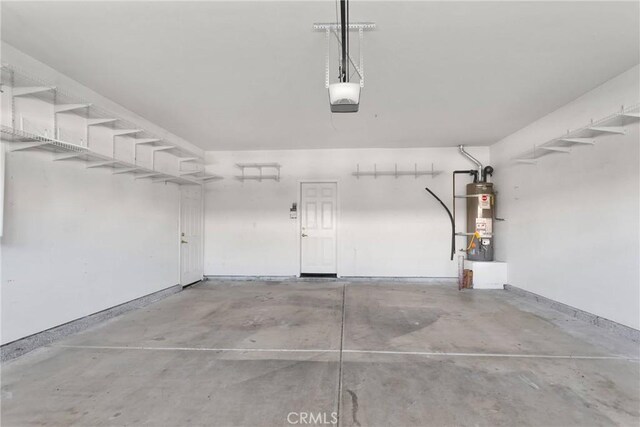 garage featuring a garage door opener and water heater