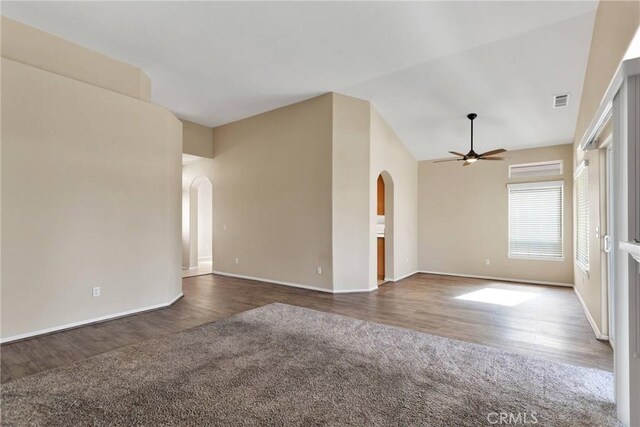 carpeted spare room featuring lofted ceiling and ceiling fan