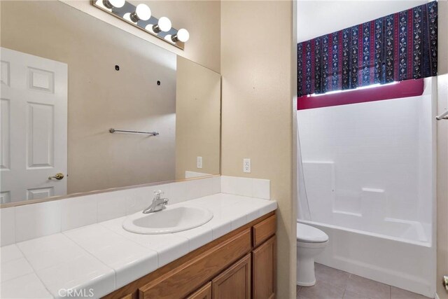 11262 Country Club Dr, Apple Valley, CA 92308 - bathroom featuring tile patterned floors, shower / bath combo with shower curtain, toilet, and vanity