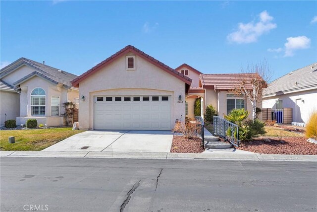 11262 Country Club Dr, Apple Valley, CA 92308 - view of front of property with stucco siding, driveway, a tile roof, and a garage