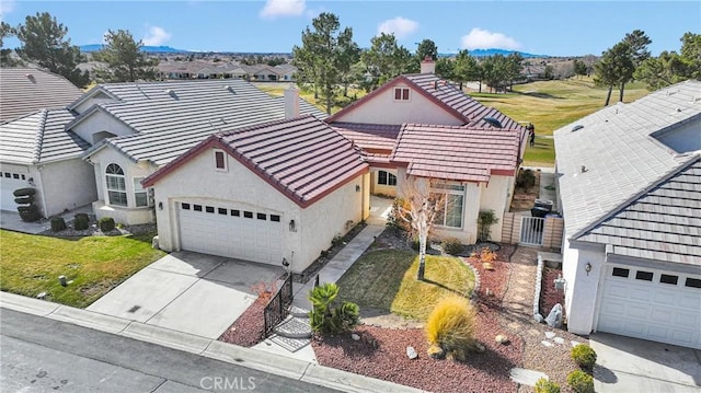 view of front of home featuring a garage and a front lawn