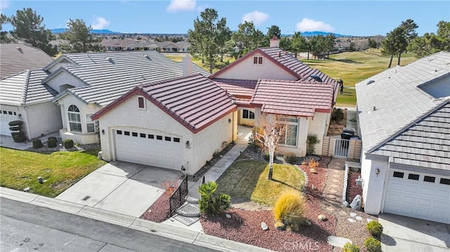 11262 Country Club Dr, Apple Valley, CA 92308 - view of front of home with stucco siding, concrete driveway, an attached garage, and a tile roof