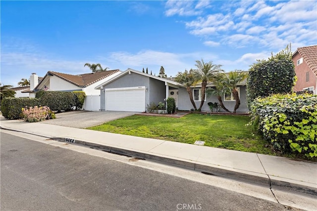 view of front of house featuring a garage and a front lawn