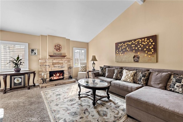 living room with a fireplace, vaulted ceiling, and carpet