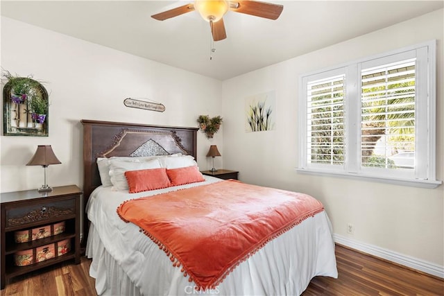 bedroom with dark hardwood / wood-style floors and ceiling fan