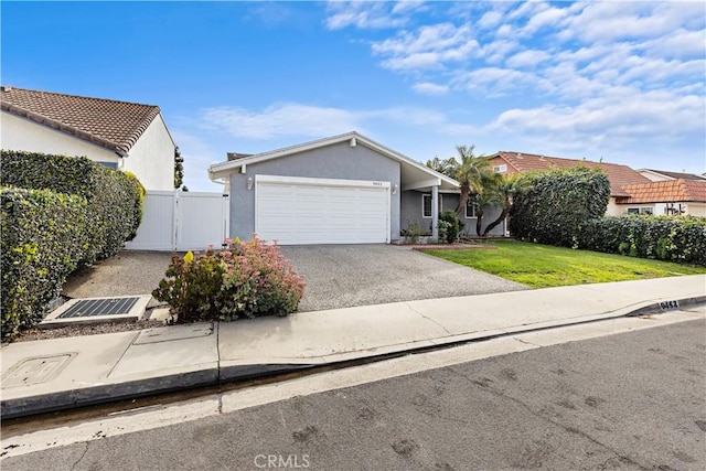 view of front of house with a garage and a front lawn