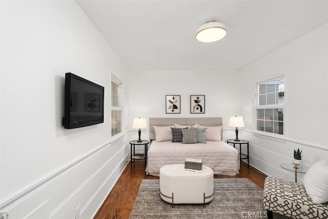 bedroom with dark hardwood / wood-style floors