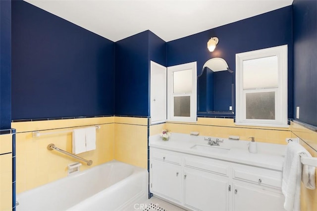 bathroom with vanity and a washtub