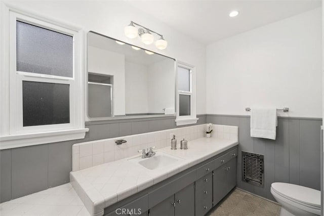 bathroom featuring vanity and toilet