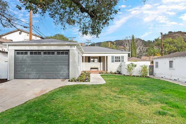 ranch-style home with a garage and a front lawn