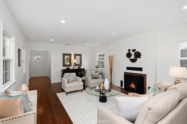 living room with hardwood / wood-style floors and a fireplace