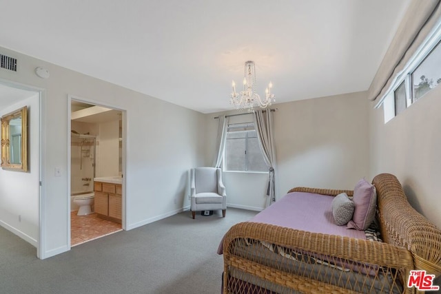 bedroom with ensuite bathroom, carpet, and a notable chandelier