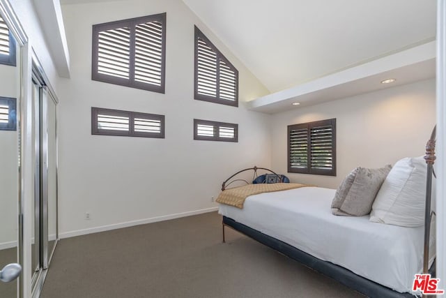 bedroom with high vaulted ceiling and dark carpet