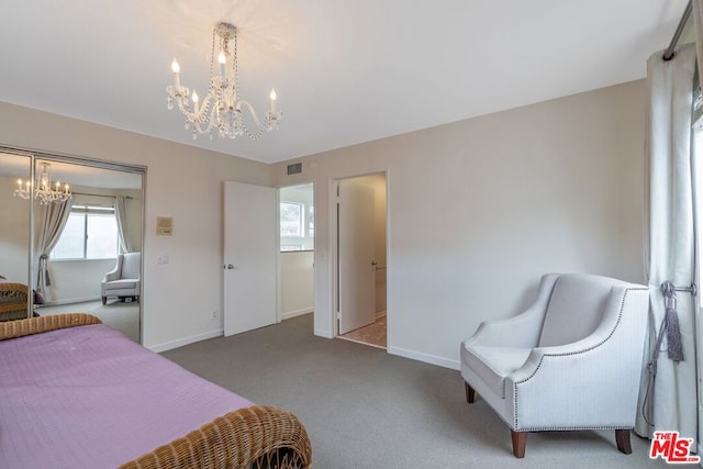 bedroom featuring carpet flooring and a notable chandelier