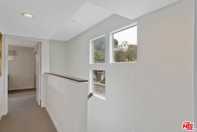 hallway featuring light colored carpet