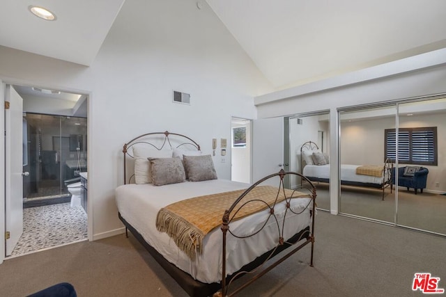 carpeted bedroom with ensuite bath, high vaulted ceiling, and two closets