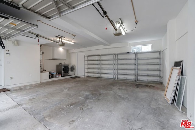 garage featuring a garage door opener and independent washer and dryer