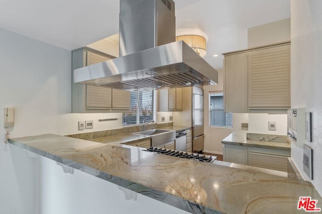 kitchen with sink, island range hood, kitchen peninsula, and cream cabinetry