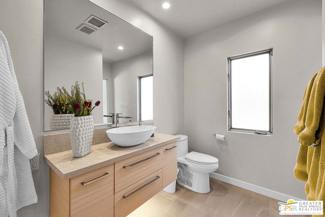 bathroom featuring vanity, tile patterned flooring, and toilet