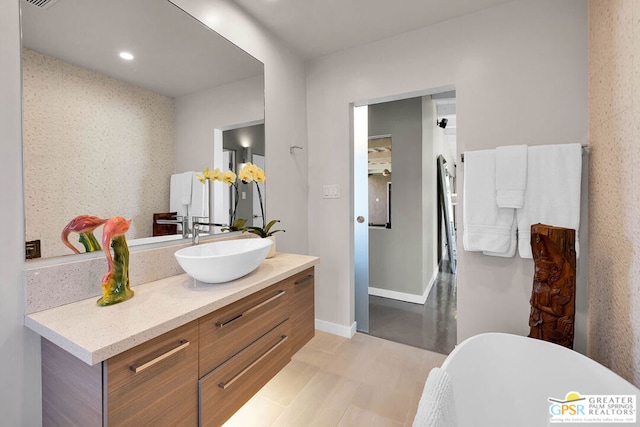 bathroom featuring vanity and a tub