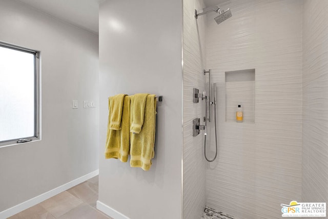 bathroom with tiled shower and a wealth of natural light