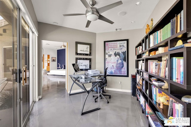 office area featuring concrete floors and ceiling fan