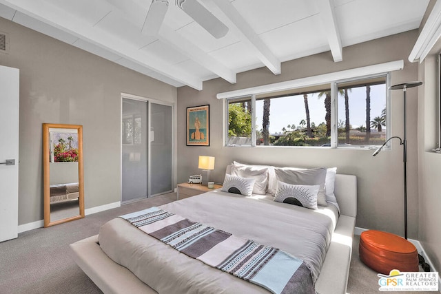 bedroom with vaulted ceiling with beams and carpet flooring