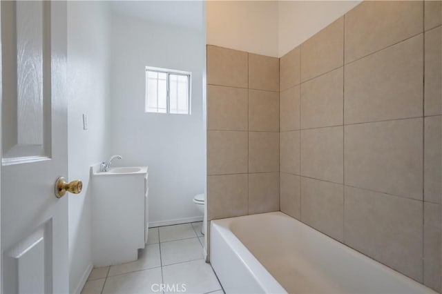 bathroom with vanity, tile patterned floors, a tub, and toilet