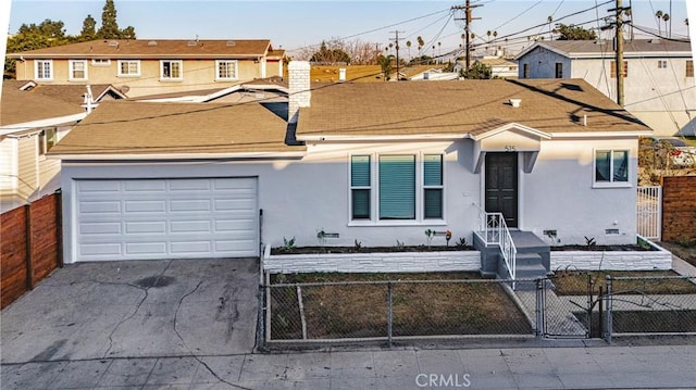 view of front of property with a garage, a fenced front yard, concrete driveway, and stucco siding