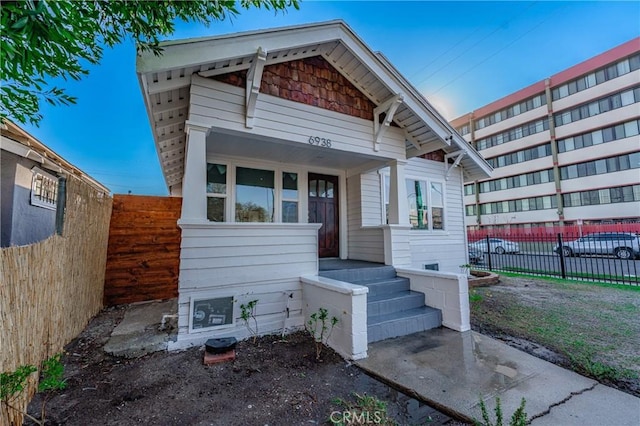 view of front of house featuring fence