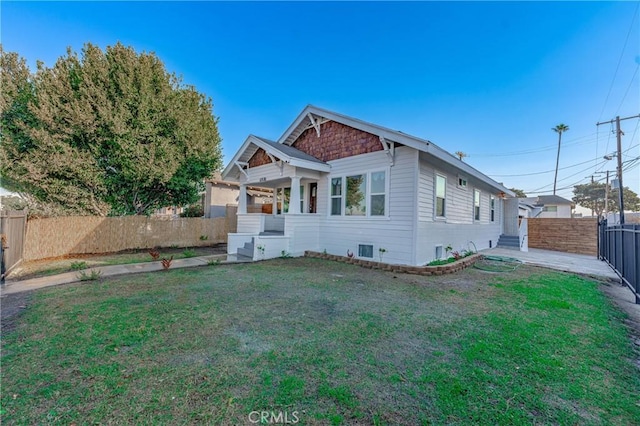 view of front facade with a front yard and a fenced backyard