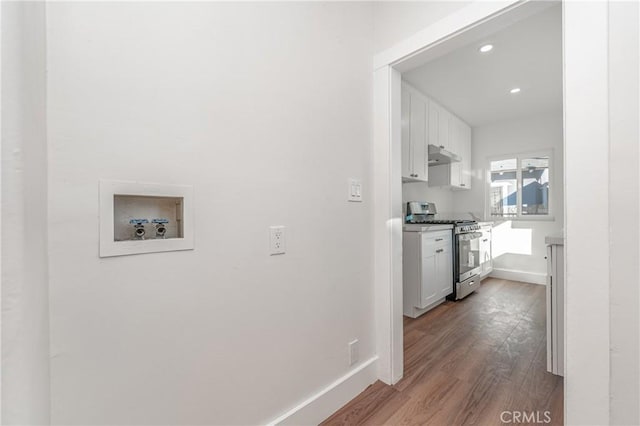 corridor featuring recessed lighting, wood finished floors, and baseboards