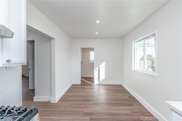 interior space with recessed lighting, light wood finished floors, and baseboards