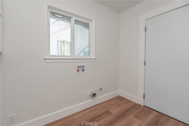 washroom featuring hookup for a washing machine and light hardwood / wood-style flooring