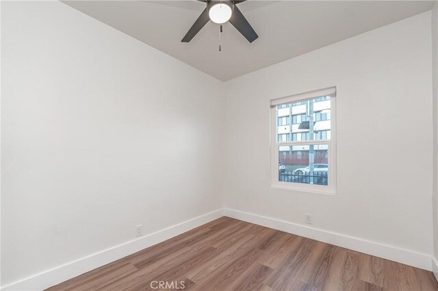 unfurnished room with ceiling fan and hardwood / wood-style floors