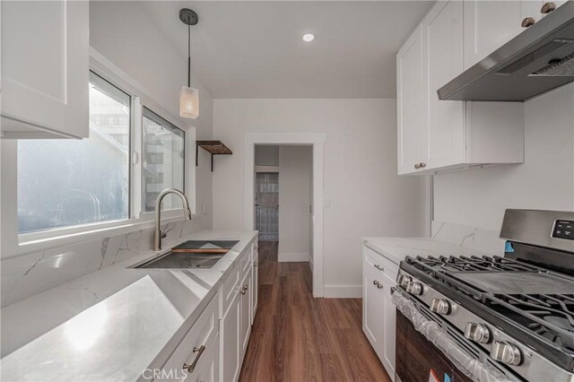 kitchen with ventilation hood, white cabinetry, sink, and stainless steel range with gas stovetop