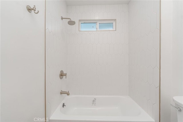 bathroom featuring shower / tub combination and toilet