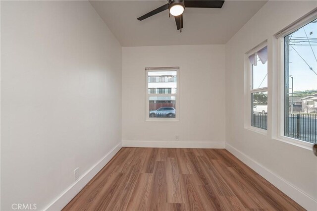 empty room with wood-type flooring and ceiling fan