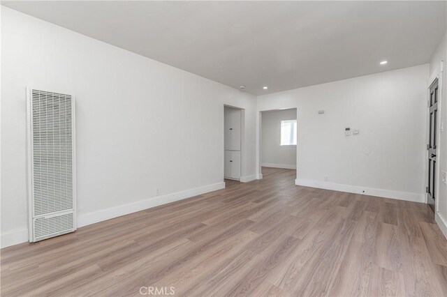 unfurnished room with light hardwood / wood-style flooring