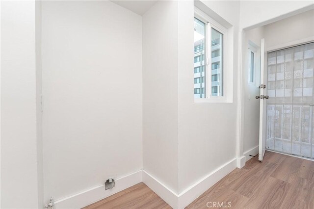 clothes washing area with hardwood / wood-style floors