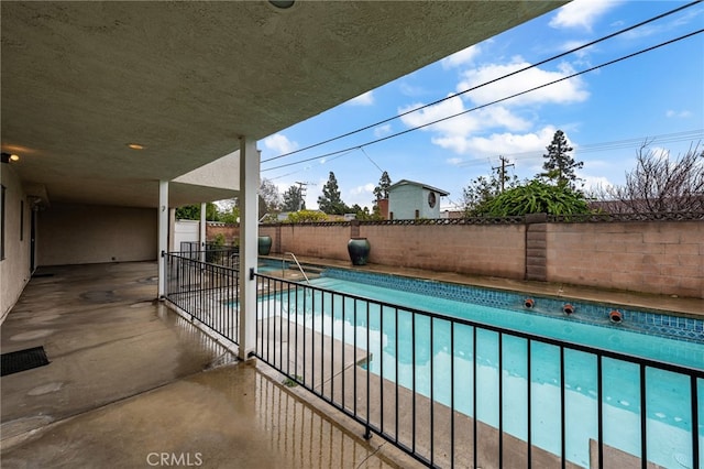 view of swimming pool featuring a patio area