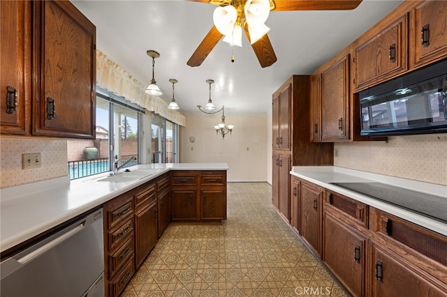 kitchen with sink, hanging light fixtures, kitchen peninsula, ceiling fan with notable chandelier, and black appliances