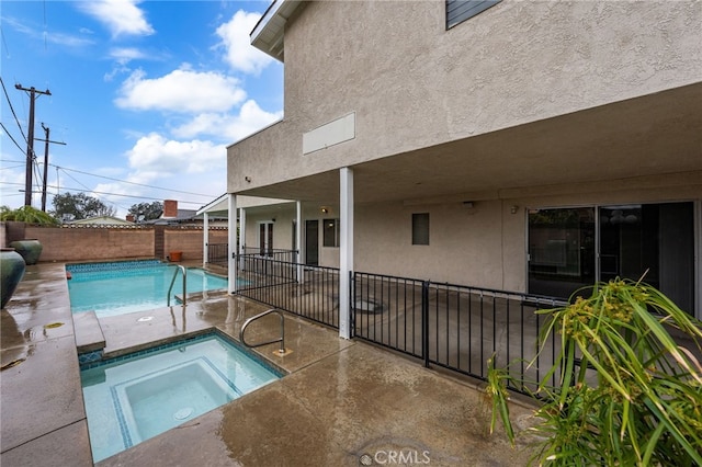 view of swimming pool with an in ground hot tub and a patio