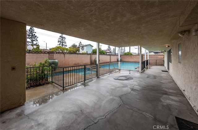 view of patio / terrace with a fenced in pool